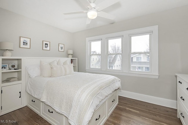 bedroom with dark wood-style floors, ceiling fan, and baseboards