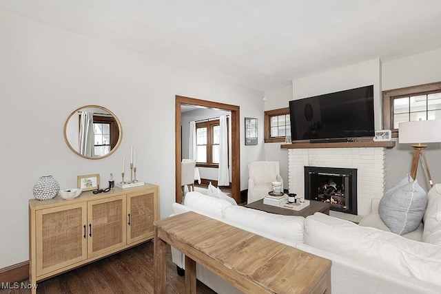 living area with dark wood-style floors and a fireplace