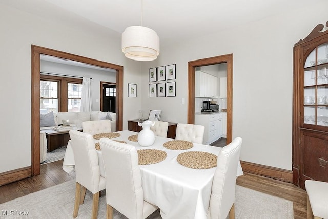 dining room featuring wood finished floors and baseboards