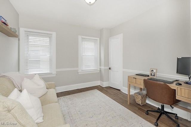 home office featuring baseboards and wood finished floors