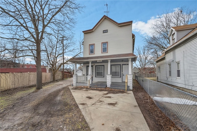 view of front of home with covered porch and fence