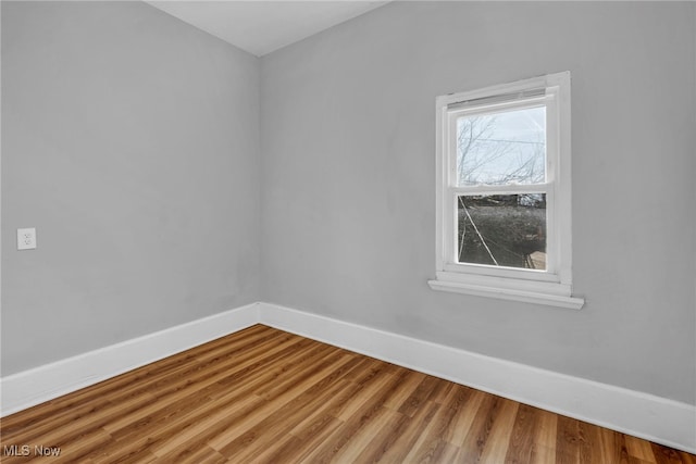 unfurnished room with wood finished floors and baseboards