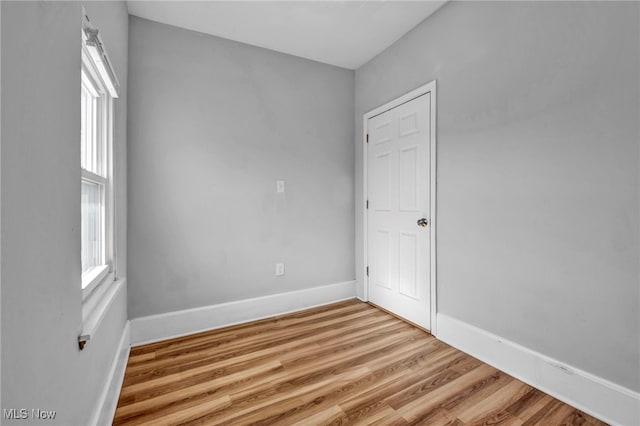 spare room with light wood-style flooring and baseboards