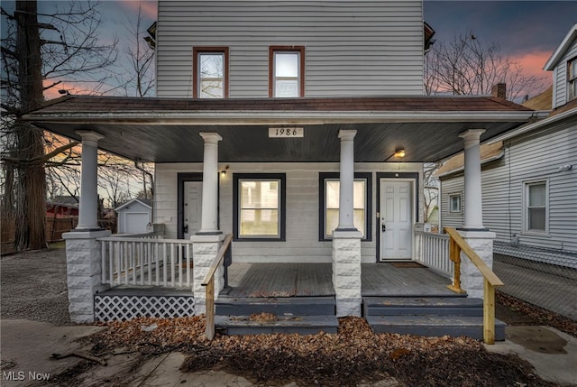 view of front of property featuring covered porch and an outdoor structure