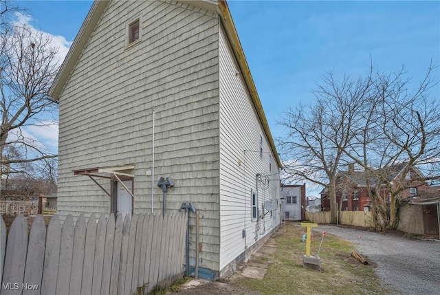 view of property exterior featuring fence