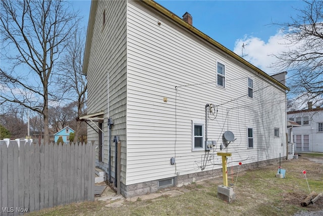 view of property exterior featuring fence