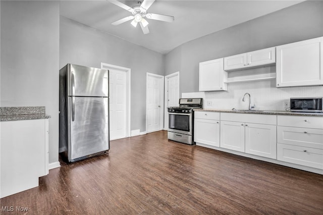 kitchen featuring decorative backsplash, white cabinets, dark wood-style floors, appliances with stainless steel finishes, and a sink