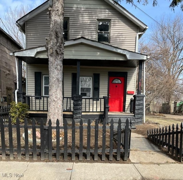 view of front of home featuring a porch and a fenced front yard