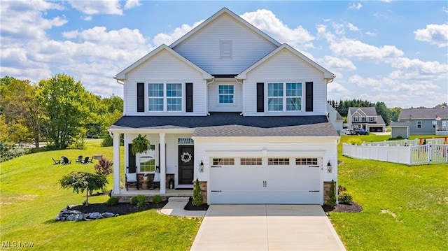 view of front of property with concrete driveway, an attached garage, covered porch, fence, and a front yard