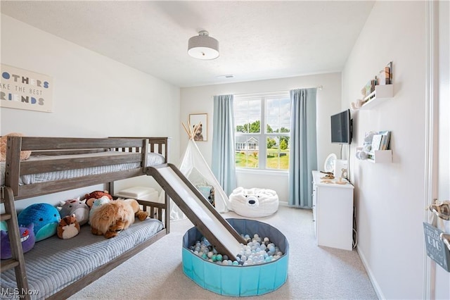 carpeted bedroom featuring baseboards