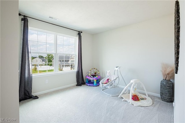 recreation room with carpet floors, visible vents, and baseboards