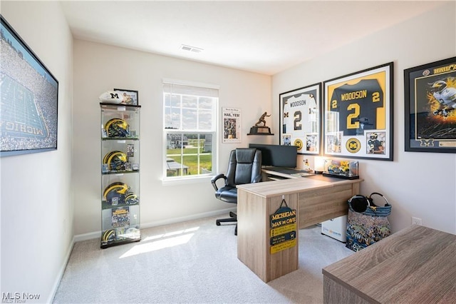 carpeted home office with visible vents and baseboards