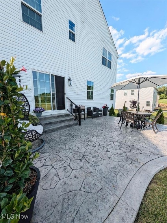 back of house featuring entry steps and a patio area