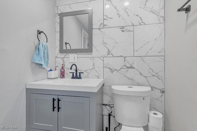 bathroom featuring toilet and vanity