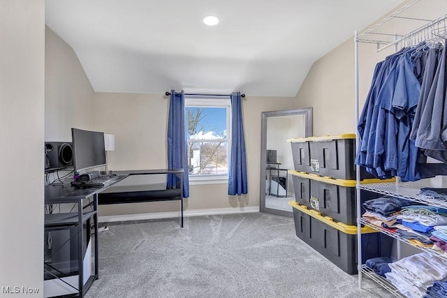 office space featuring carpet floors, vaulted ceiling, and baseboards