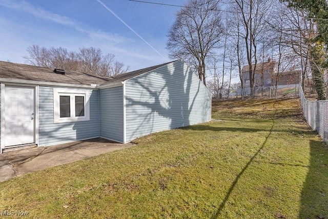 view of side of property with a yard and fence