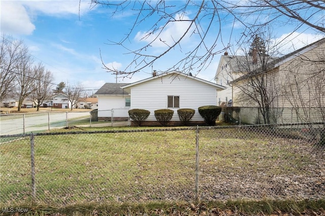 view of home's exterior featuring a lawn and fence private yard