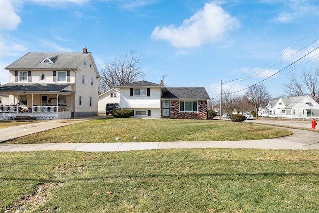 view of front of property featuring concrete driveway and a front yard