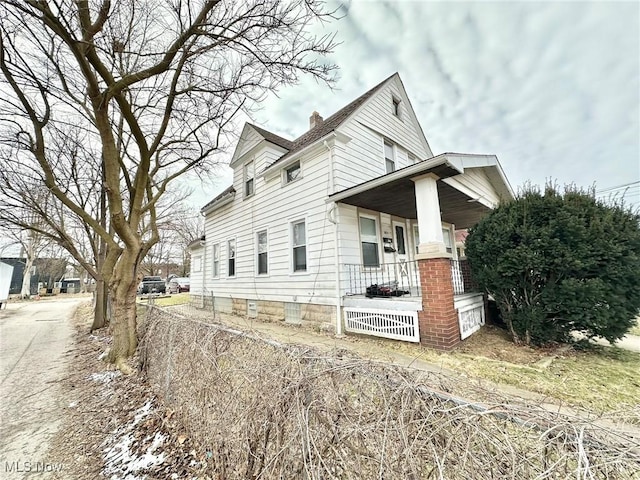 view of side of property featuring a porch