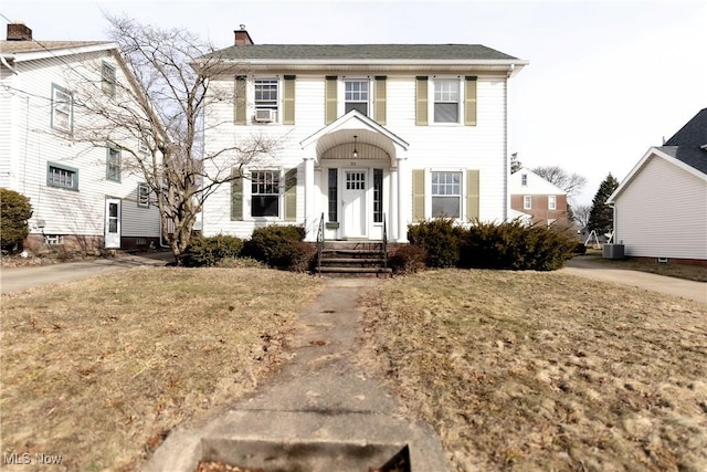 colonial-style house featuring a chimney