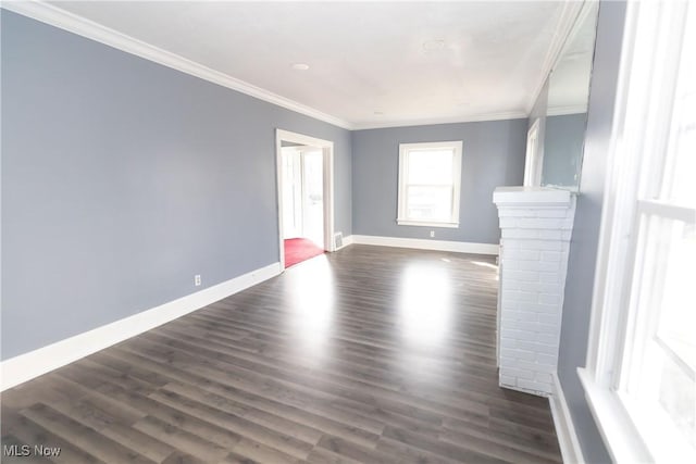 unfurnished living room featuring ornamental molding, dark wood-style flooring, and baseboards