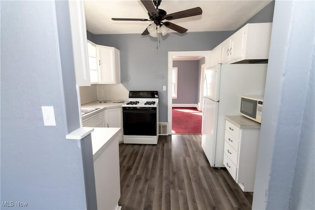 kitchen with dark wood-style floors, white appliances, and white cabinetry