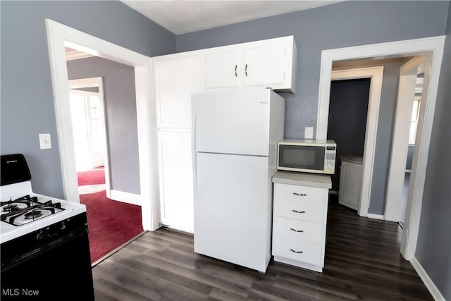 kitchen featuring white appliances, white cabinetry, baseboards, light countertops, and dark wood finished floors