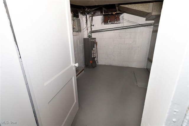 unfinished below grade area with electric panel and water heater