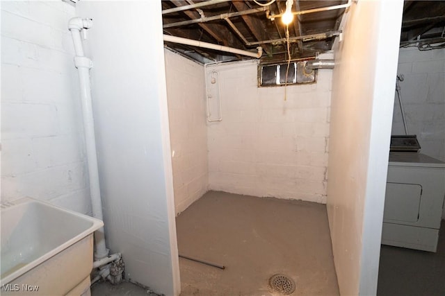 unfinished basement featuring washer / dryer and a sink