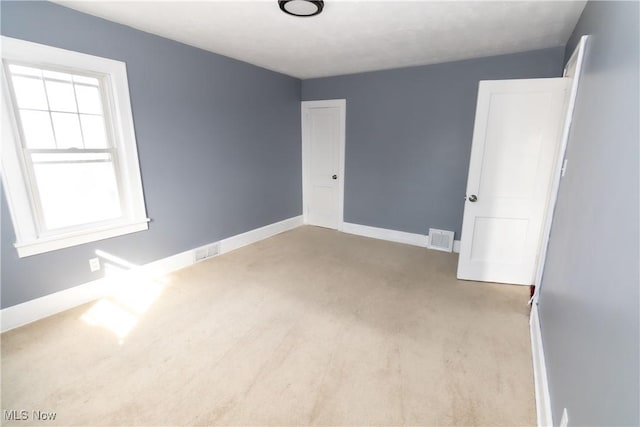 spare room with visible vents and baseboards