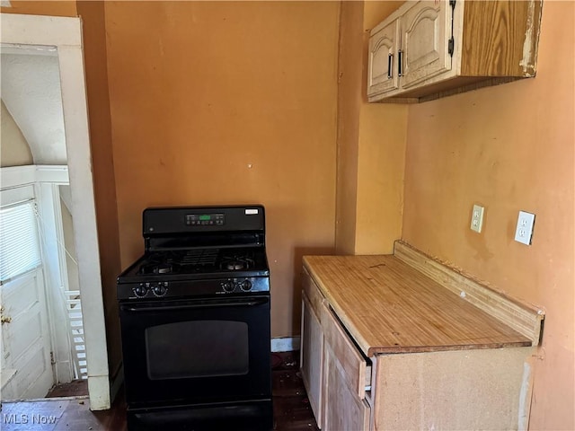 kitchen featuring black gas stove and light countertops