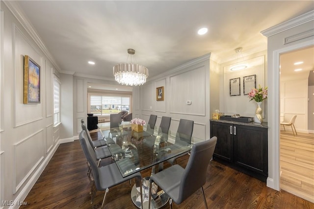 dining area with a notable chandelier, crown molding, a decorative wall, and dark wood-style flooring