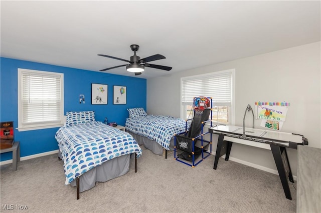 bedroom with multiple windows, baseboards, and carpet flooring