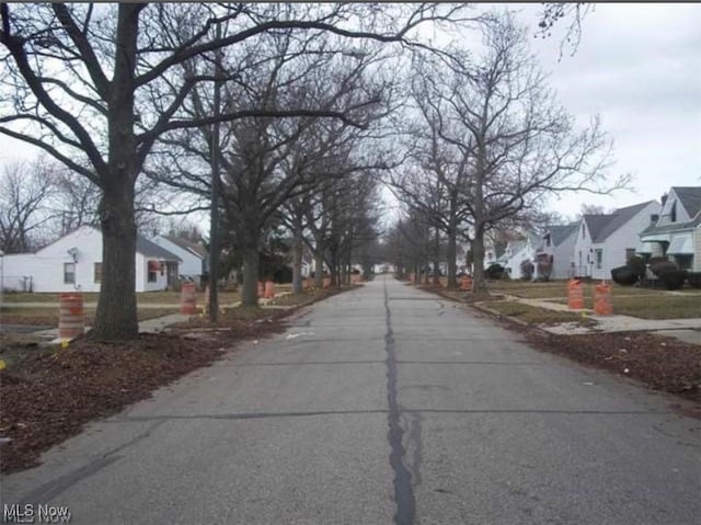 view of road with sidewalks and a residential view