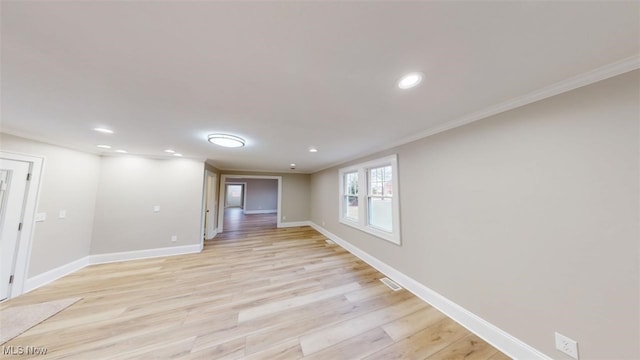 empty room with ornamental molding, light wood-type flooring, recessed lighting, and baseboards