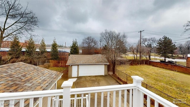 view of yard with a garage, fence, and an outdoor structure