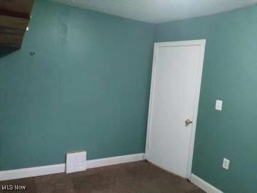 spare room featuring visible vents and baseboards