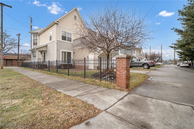 view of side of property featuring a fenced front yard