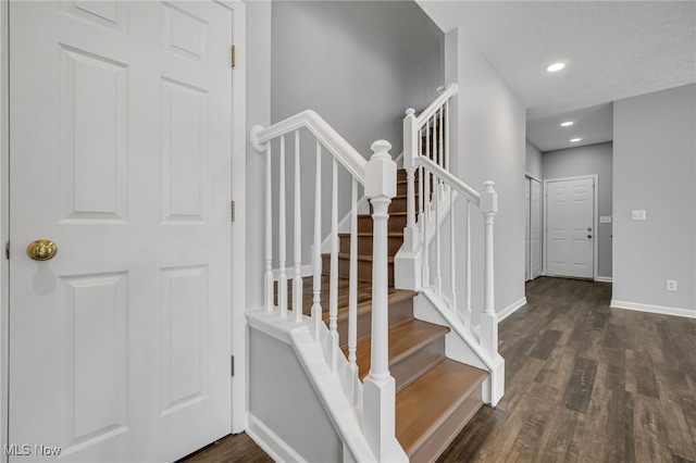 staircase featuring recessed lighting, wood finished floors, and baseboards