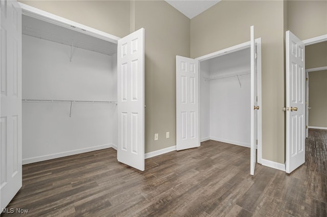 unfurnished bedroom featuring a closet, wood finished floors, and baseboards