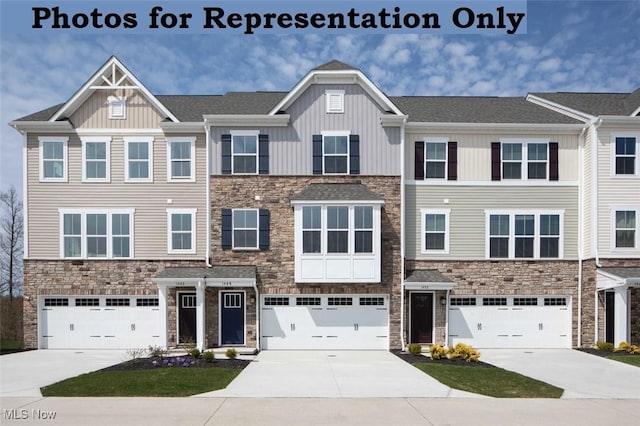 multi unit property with a garage, concrete driveway, board and batten siding, and stone siding