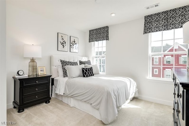 bedroom featuring light carpet, baseboards, and visible vents