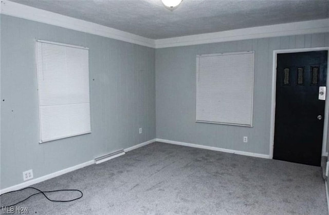 carpeted spare room with a textured ceiling, visible vents, and baseboards