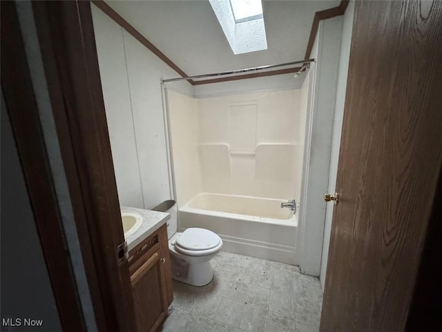 bathroom featuring a skylight, shower / tub combination, vanity, and toilet