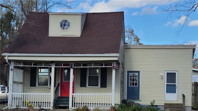 view of front of home featuring a shingled roof, entry steps, and covered porch