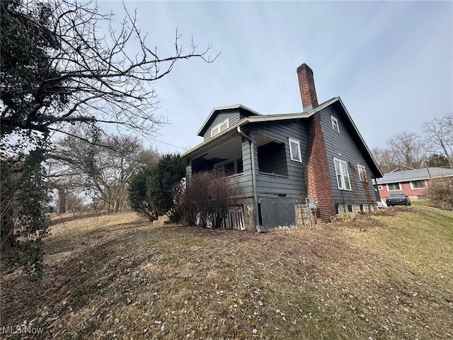 view of side of home featuring a chimney