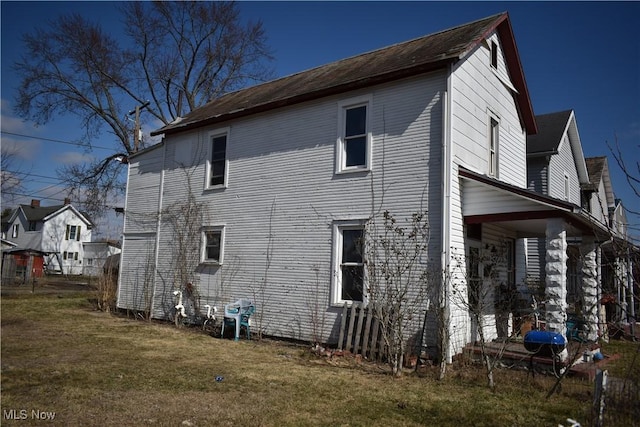 view of side of home featuring a yard