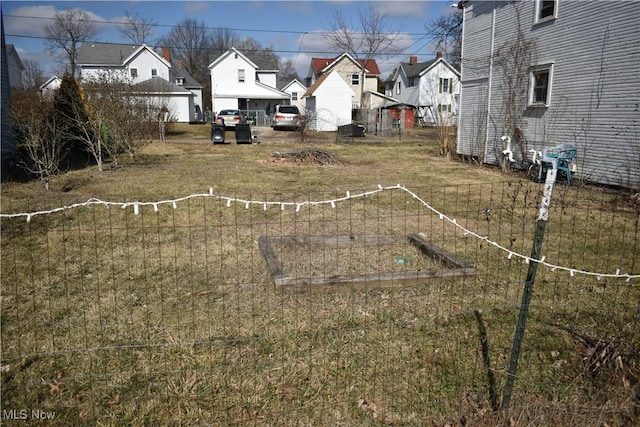 view of yard featuring a garden and a residential view