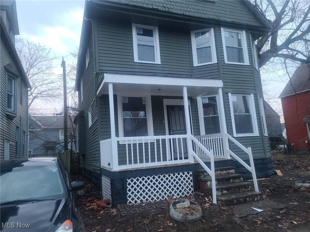 american foursquare style home with a porch