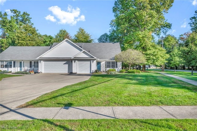 view of front facade with a front lawn, driveway, and an attached garage